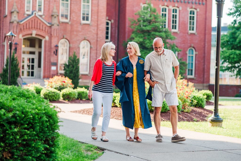 wvu grad and parents walking through woodburn circle before graduation in morgantown wv