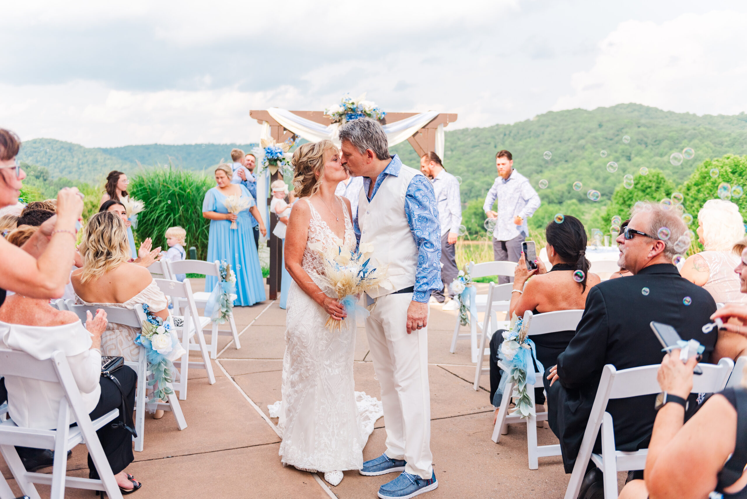 wedding couple walking down the aisle to bubbles