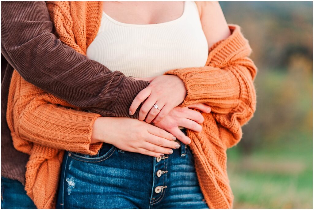 fiance's arms wrapped around his girlfriend's waist at West Virginia engagement session