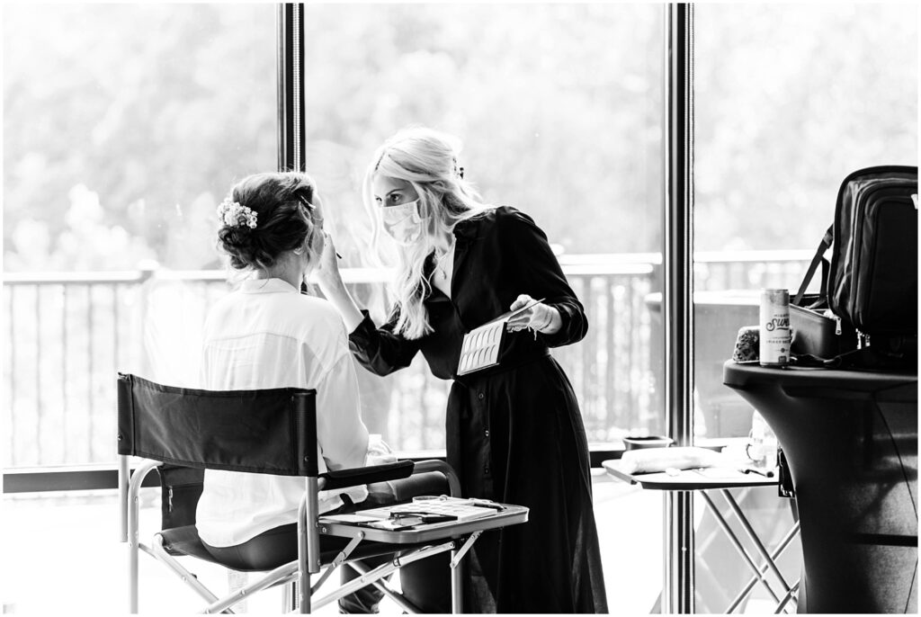 bride getting her makeup applied before the wedding ceremony in WV