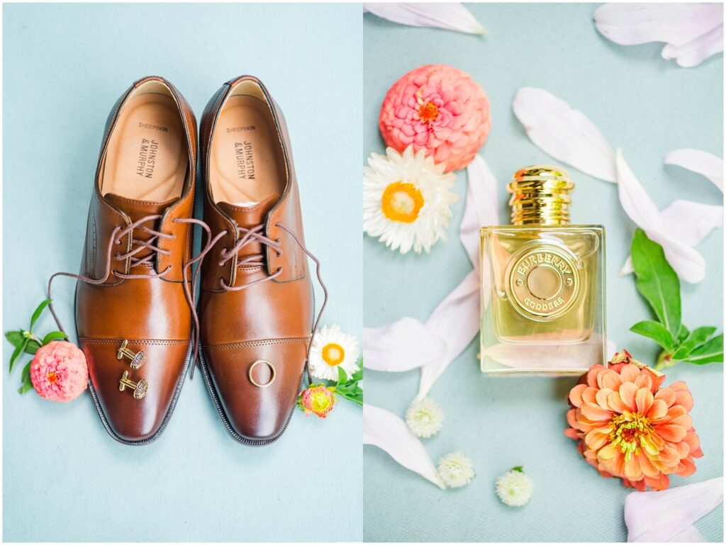 a bottle of cologne sitting on a blue mat surrounded by bright flowers 