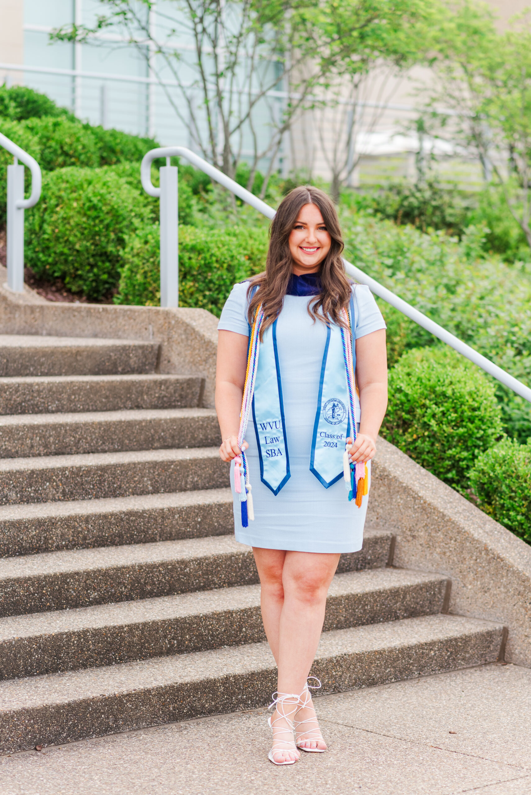 WVU law school graduate posing with her cords and stole