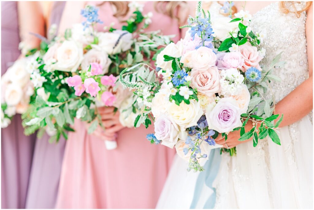 bride and bridesmaids holding fresh flower bouquets at West Virginia wedding