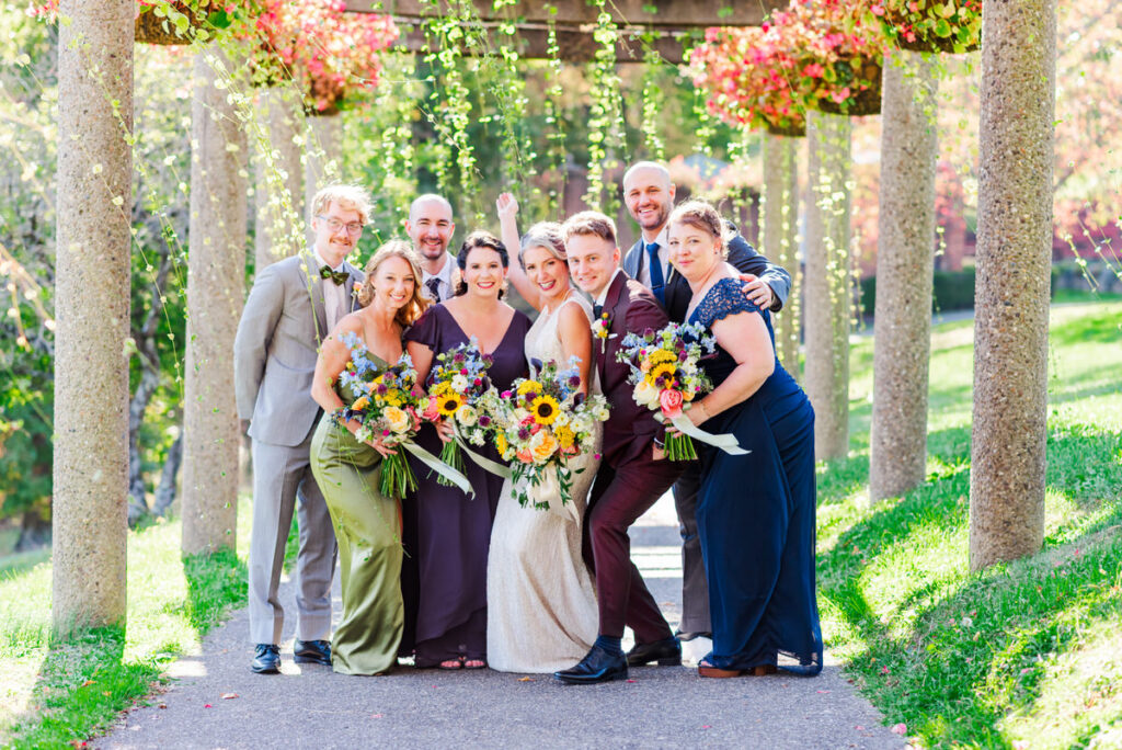 bride  groom smiling with their bridal party