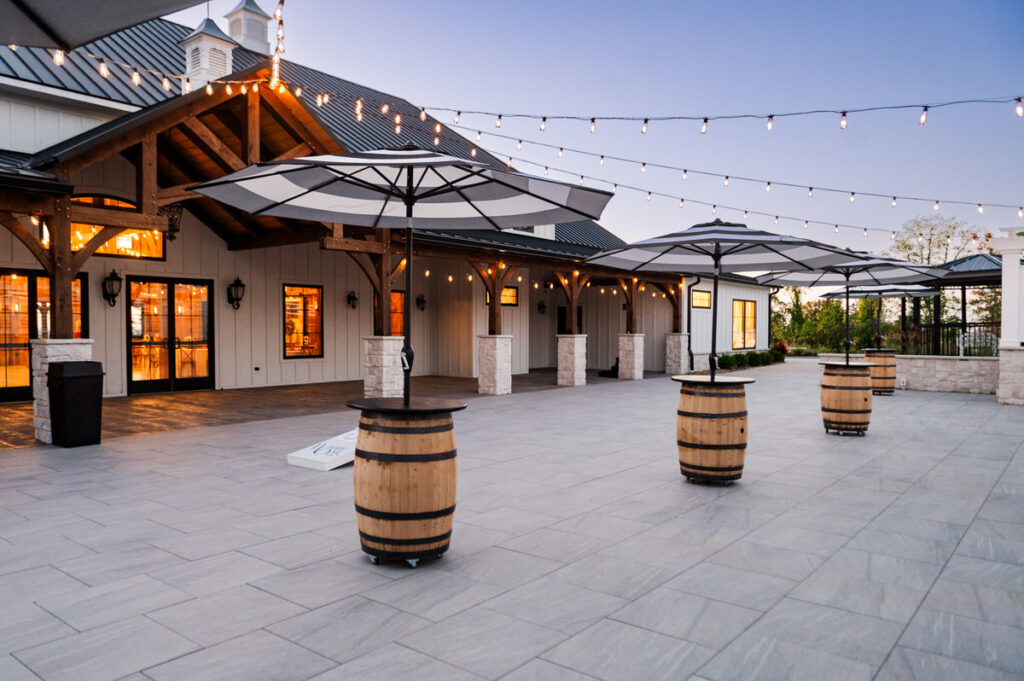 cocktail hour patio with whisky barrels and umbrellas