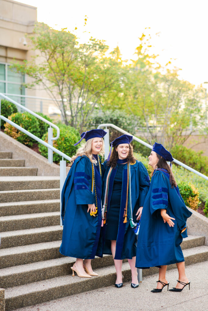 three wvu law grads laughing during their wvu grad photos session