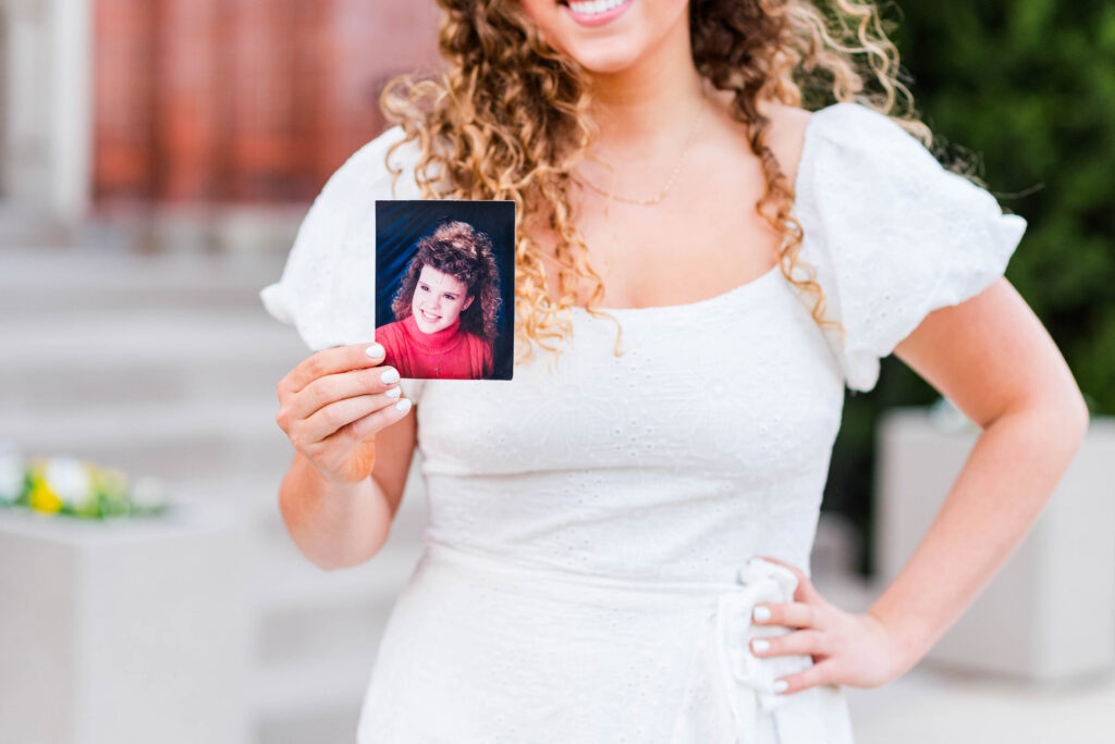 wvu grad holding picture of her mother as a child at woodburn circle in morgantown wv