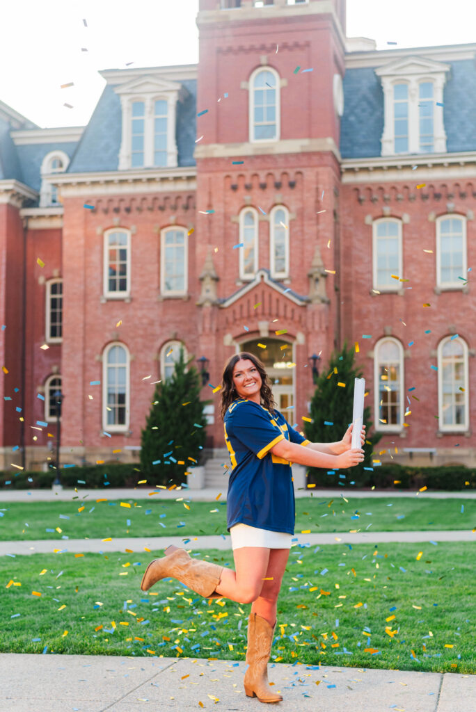wvu grad popping confetti cannon at woodburn circle in morgantown wv during wvu grad photos